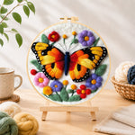 Finished vibrant butterfly and flowers needle felting displayed on a wooden easel