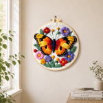 Vibrant butterfly and flowers needle felt wall art displayed in a bright home interior