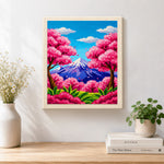 Finished vibrant cherry blossom trees and snowy peak artwork displayed on a wall