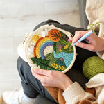 Creating handmade vibrant countryside rainbow and river punch needle artwork