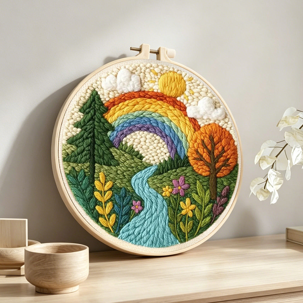 Vibrant countryside rainbow and river punch needle artwork displayed on a table