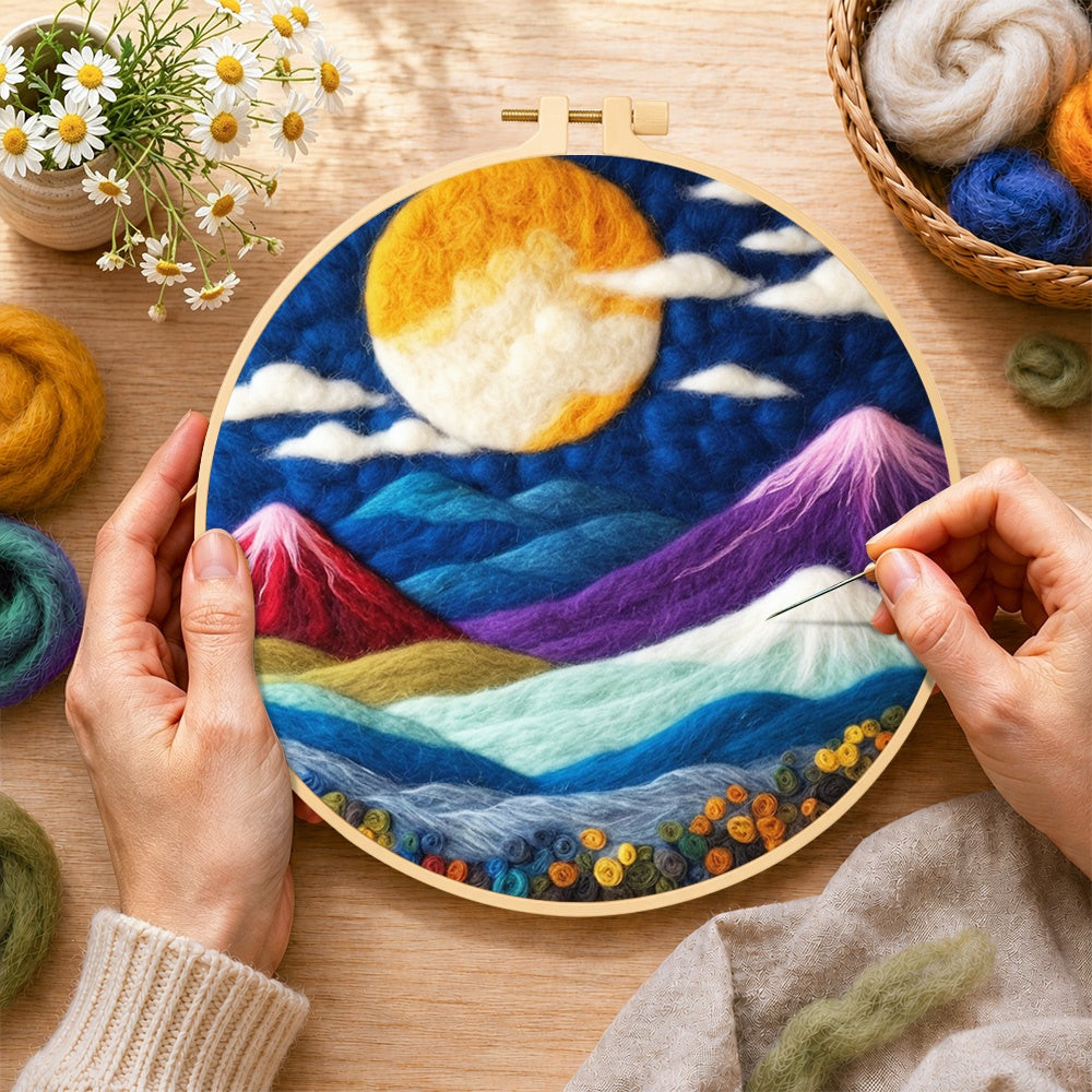 Creating the vibrant full moon over mystical peaks wool painting by hand with a felting needle