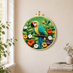 Vibrant jungle parrot needle felt wall art displayed in a bright home interior