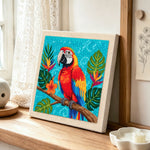 Vibrant macaw parrot punch needle artwork displayed on a table
