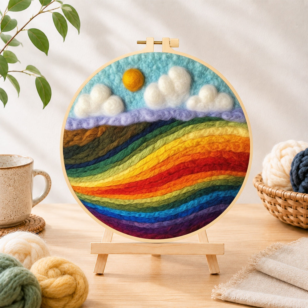 Finished vibrant rainbow colour block landscape needle felting displayed on a wooden easel