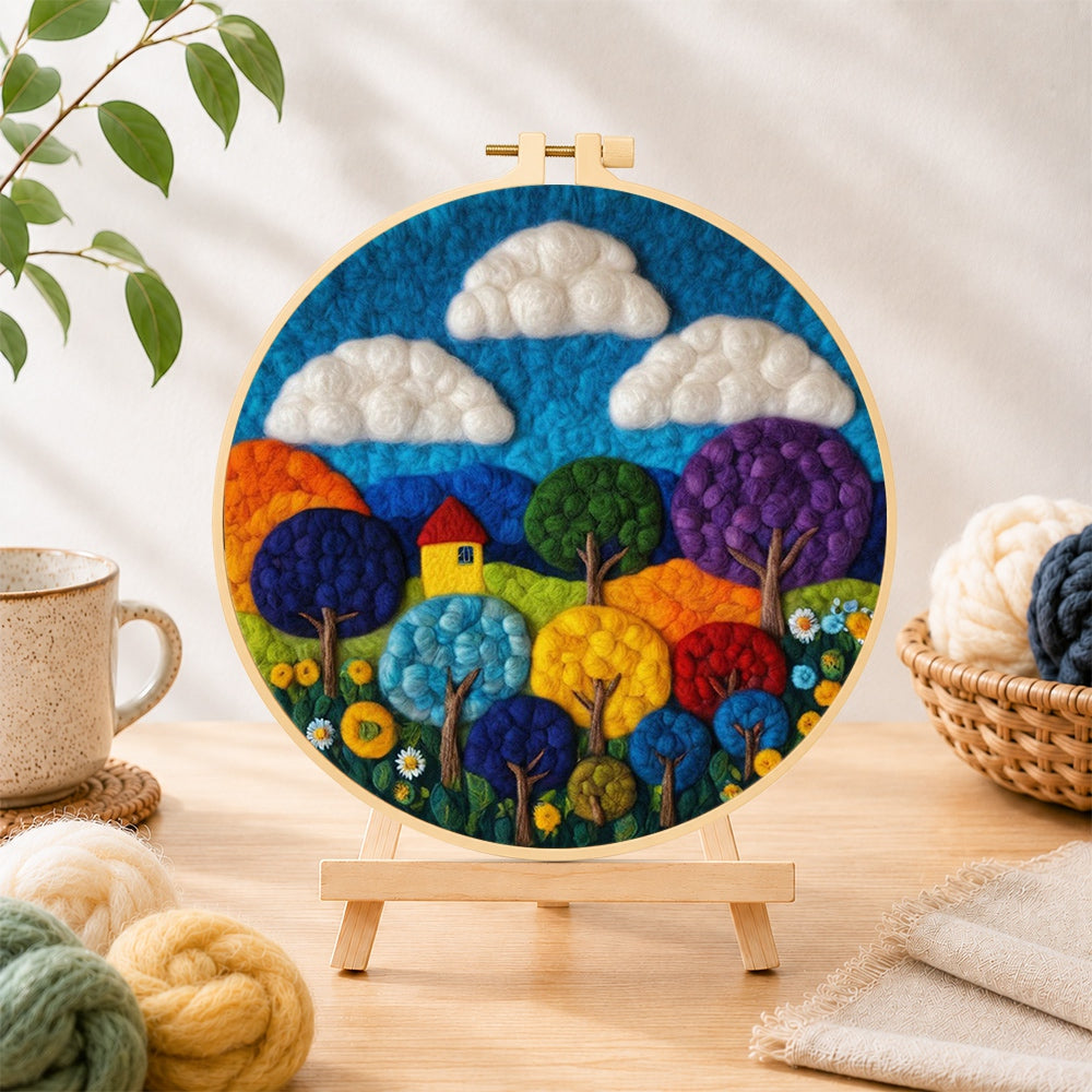 Finished vibrant rainbow trees needle felting displayed on a wooden easel