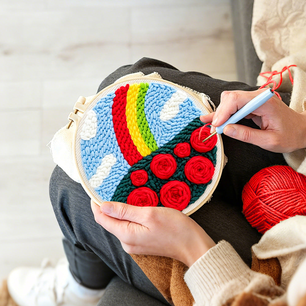 Creating handmade vibrant rainbow with red roses punch needle artwork