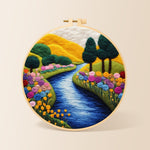 Vibrant rolling hills, sunny river and rainbow flowers needle felting kit for beginners with a round wooden frame