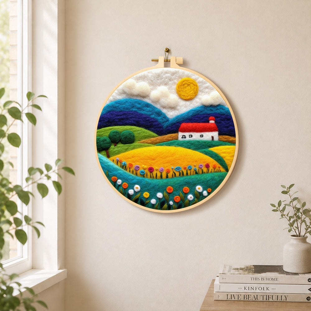 Vibrant rural fields needle felt wall art displayed in a bright home interior