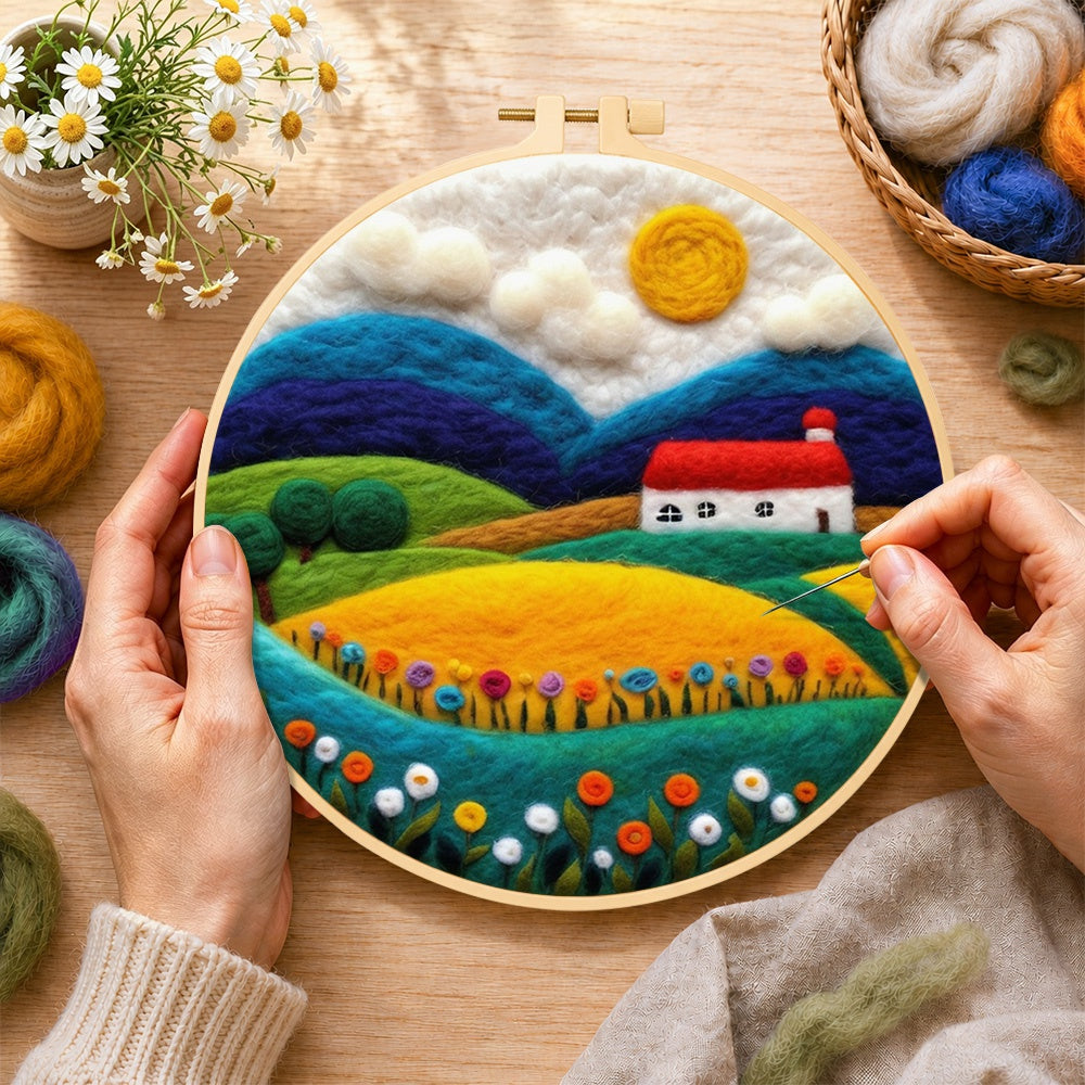 Creating the vibrant rural fields wool painting by hand with a felting needle