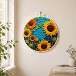 Vibrant sunflowers on blue needle felt wall art displayed in a bright home interior