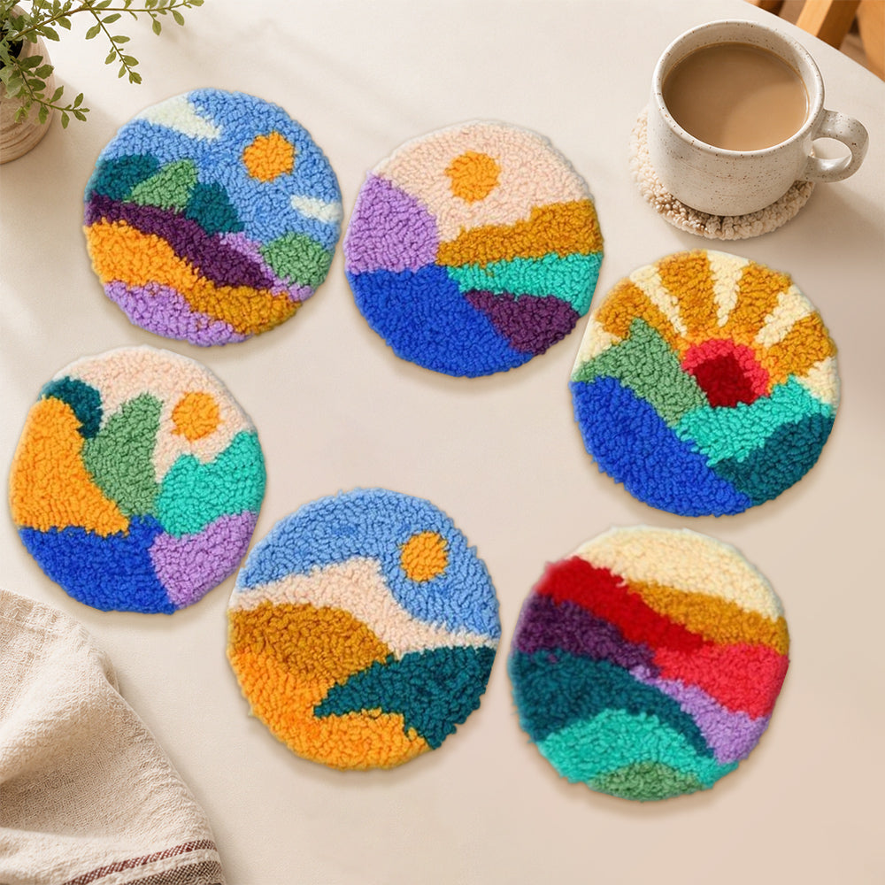 Vibrant sunrise and mountains punch needle coasters used for home decoration