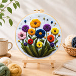Finished vibrant tall wildflowers needle felting displayed on a wooden easel