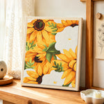 Vibrant yellow sunflowers punch needle artwork displayed on a table