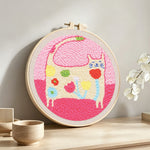 Warm and lovely flower cat punch needle artwork displayed on a table