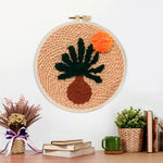 Finished warm boho desert plant artwork displayed on a wall