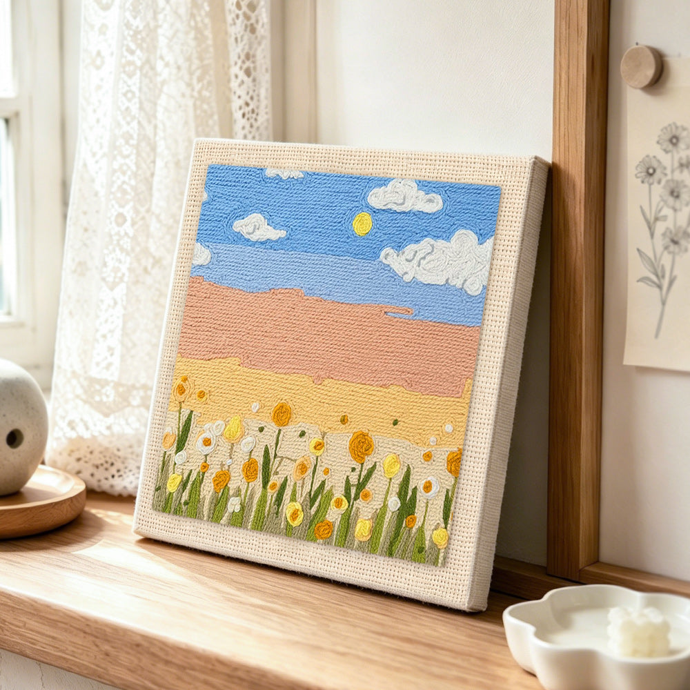 Warm golden sunlight and flowers punch needle artwork displayed on a table