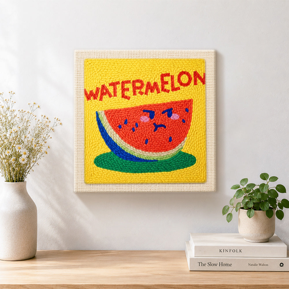 Finished watermelon with cute face artwork displayed on a wall