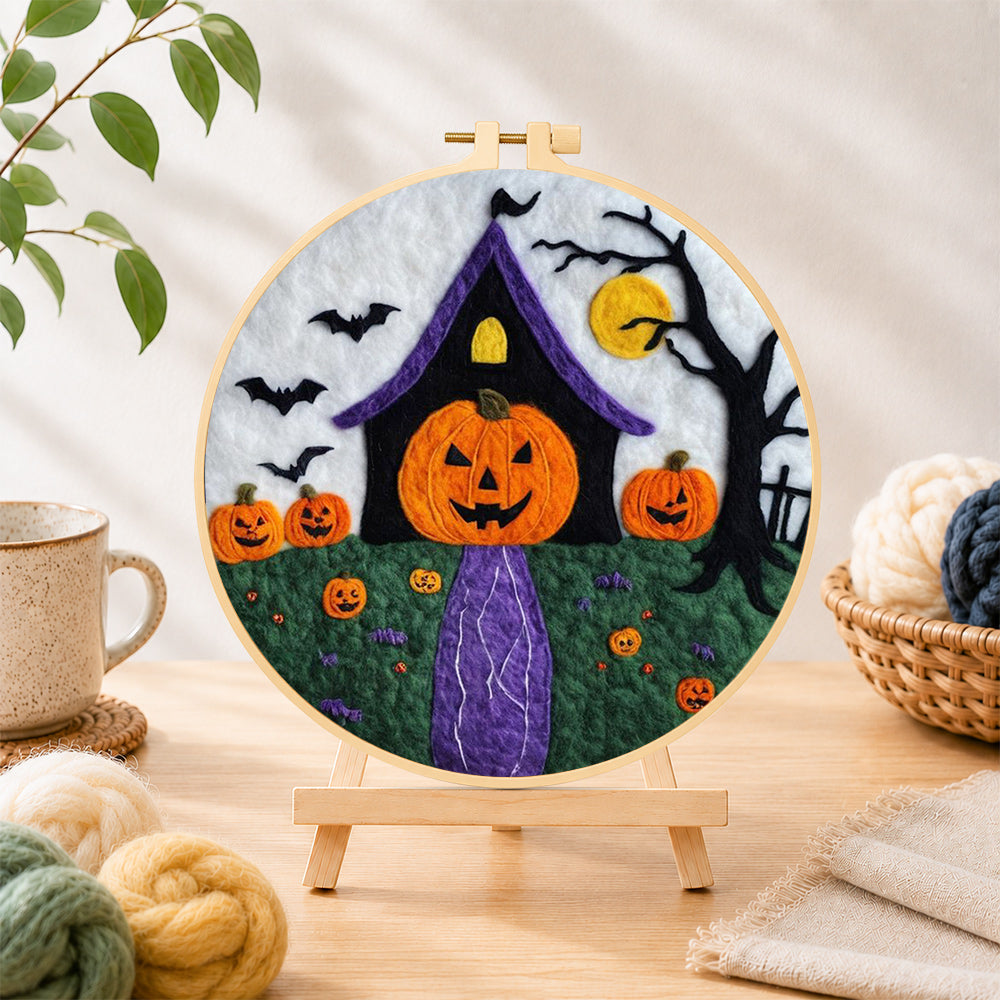 Finished weird pumpkin head house needle felting displayed on a wooden easel