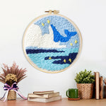 Finished whale and iceberg ocean artwork displayed on a wall