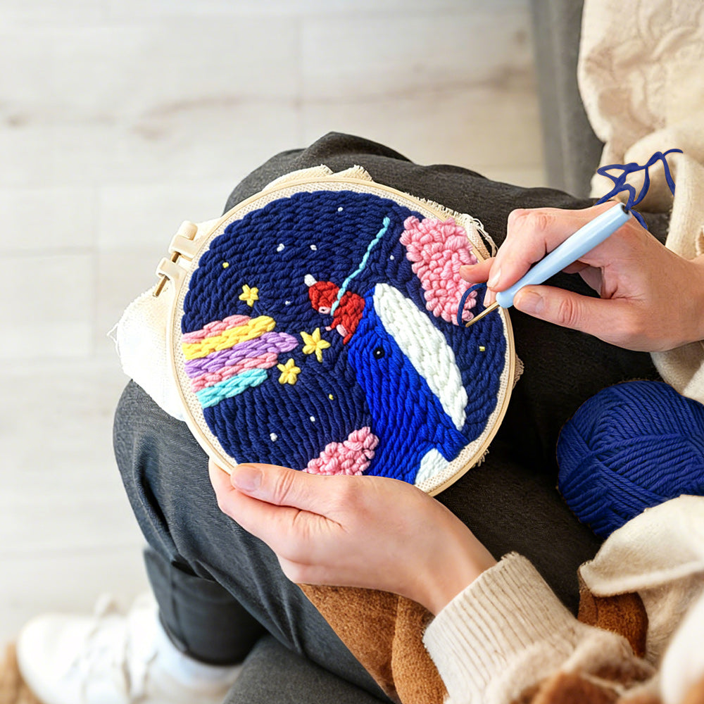 Creating handmade whale in night sky with rainbow and clouds punch needle artwork