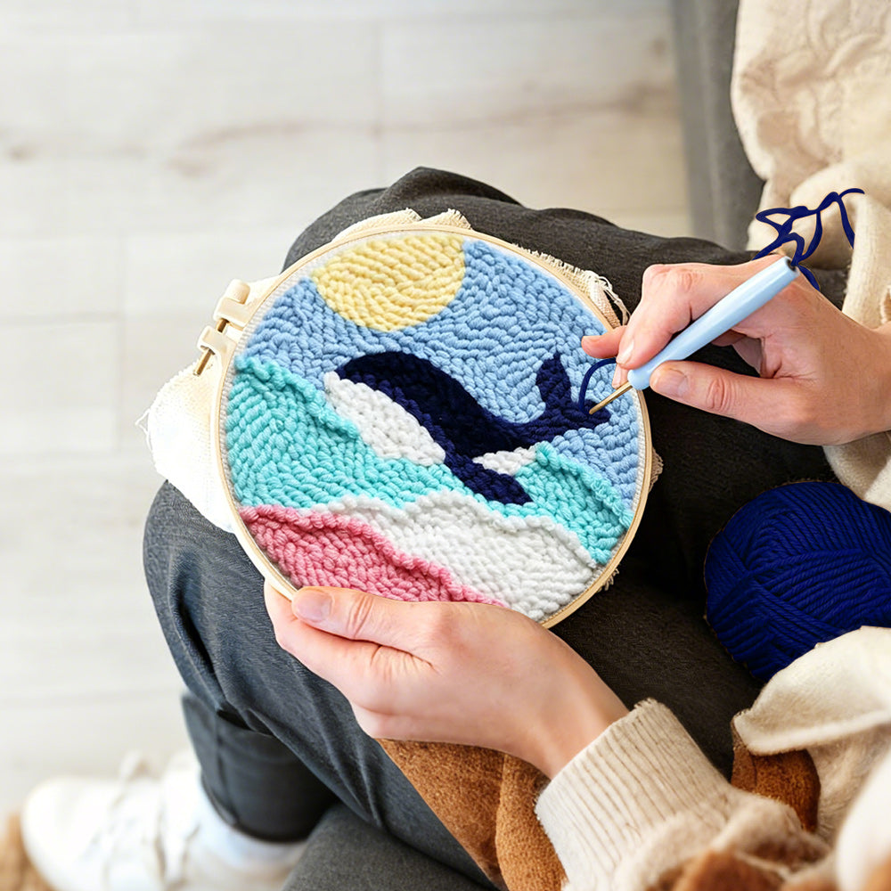 Creating handmade whale jumping over rainbow waves punch needle artwork
