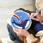 Creating handmade whale riding astronaut with rainbow sky punch needle artwork