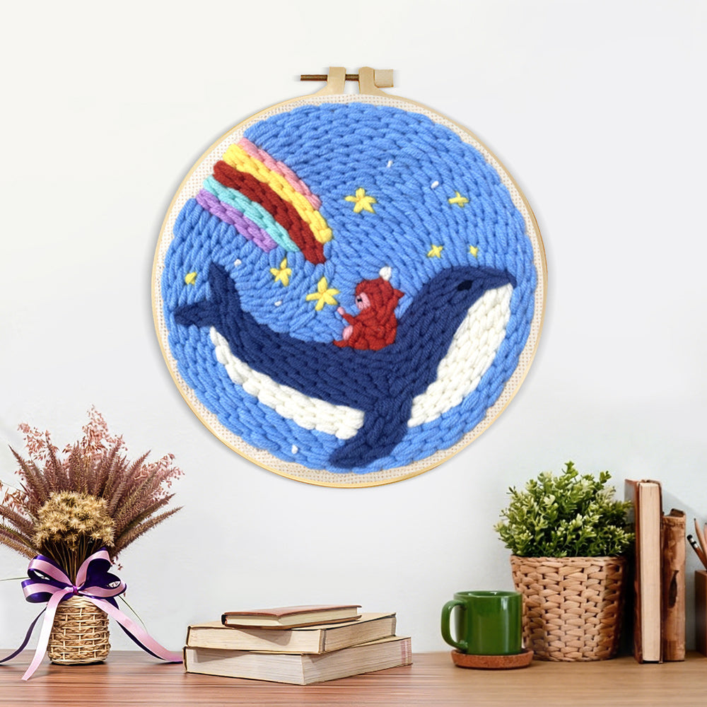 Finished whale riding astronaut with rainbow sky artwork displayed on a wall