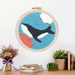 Finished whale swimming under the sea artwork displayed on a wall