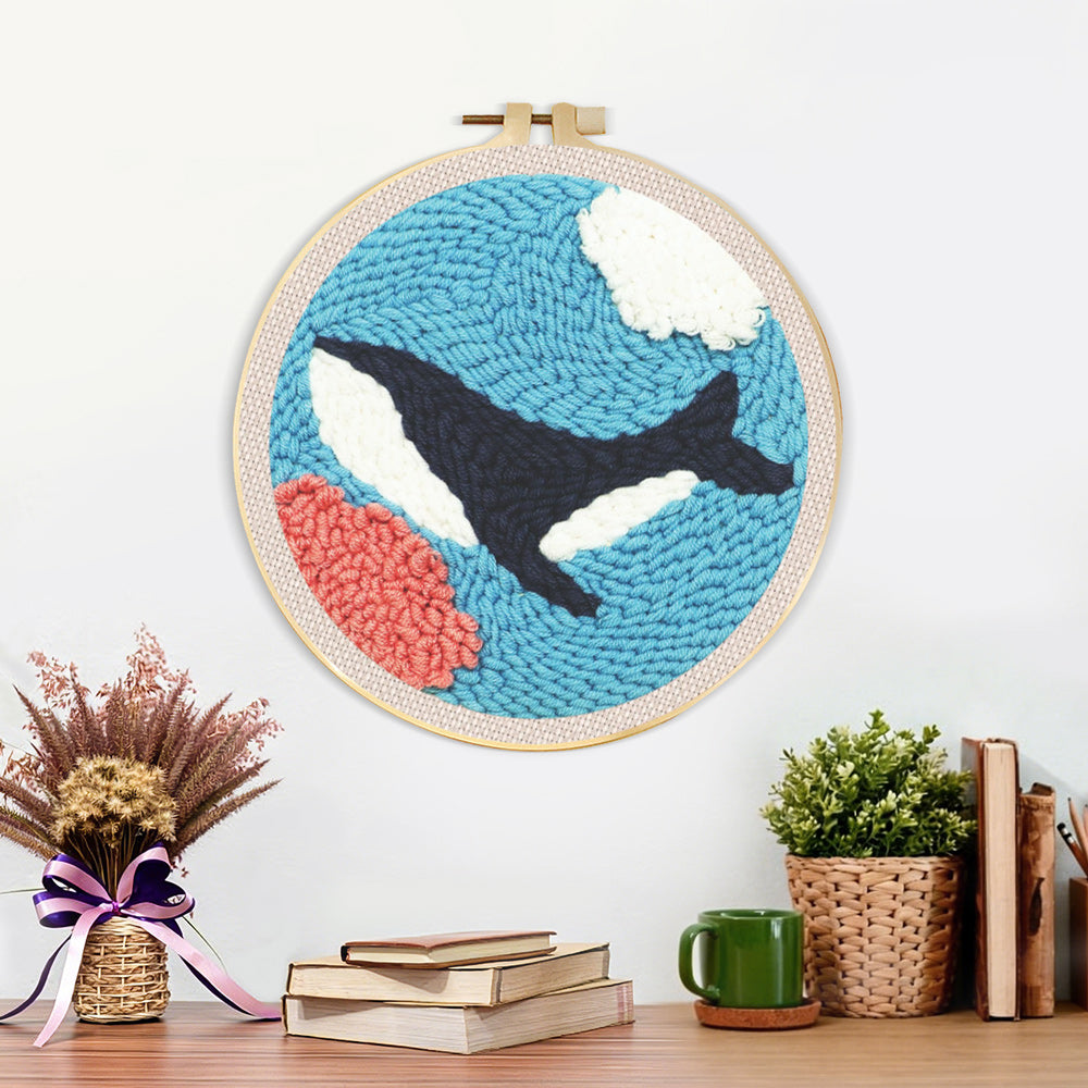 Finished whale swimming under the sea artwork displayed on a wall