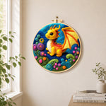 Whimsical baby dragon and colourful spiral plant needle felt wall art displayed in a bright home interior