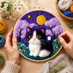 Creating the whimsical cat under the purple night sky wool painting by hand with a felting needle