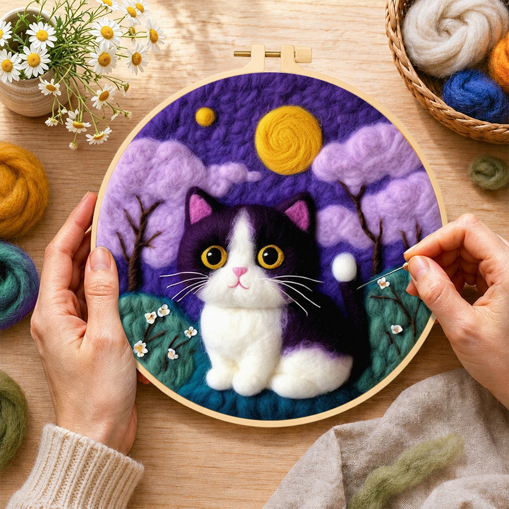 Creating the whimsical cat under the purple night sky wool painting by hand with a felting needle