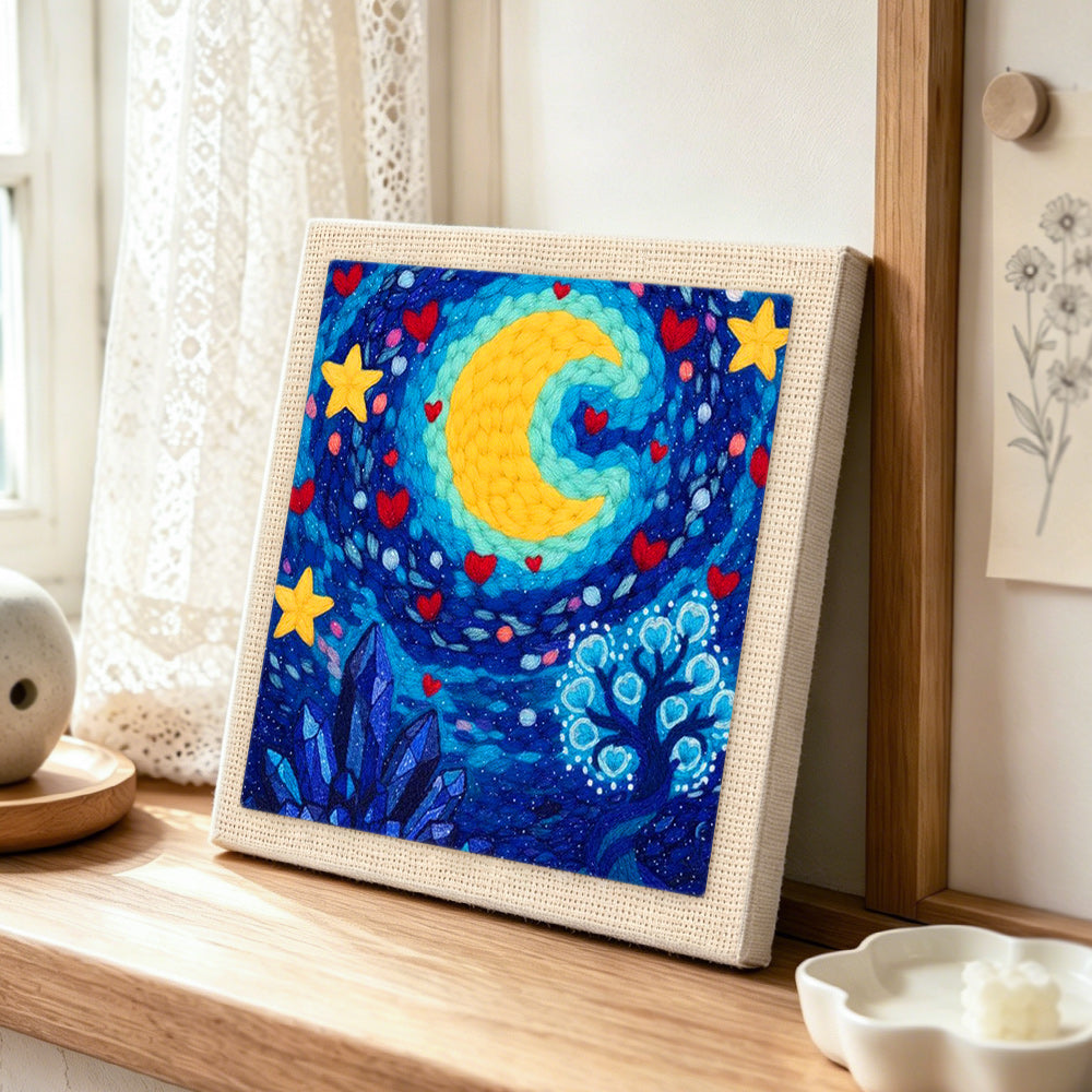 Whimsical crescent moon, stars and crystal tree punch needle artwork displayed on a table