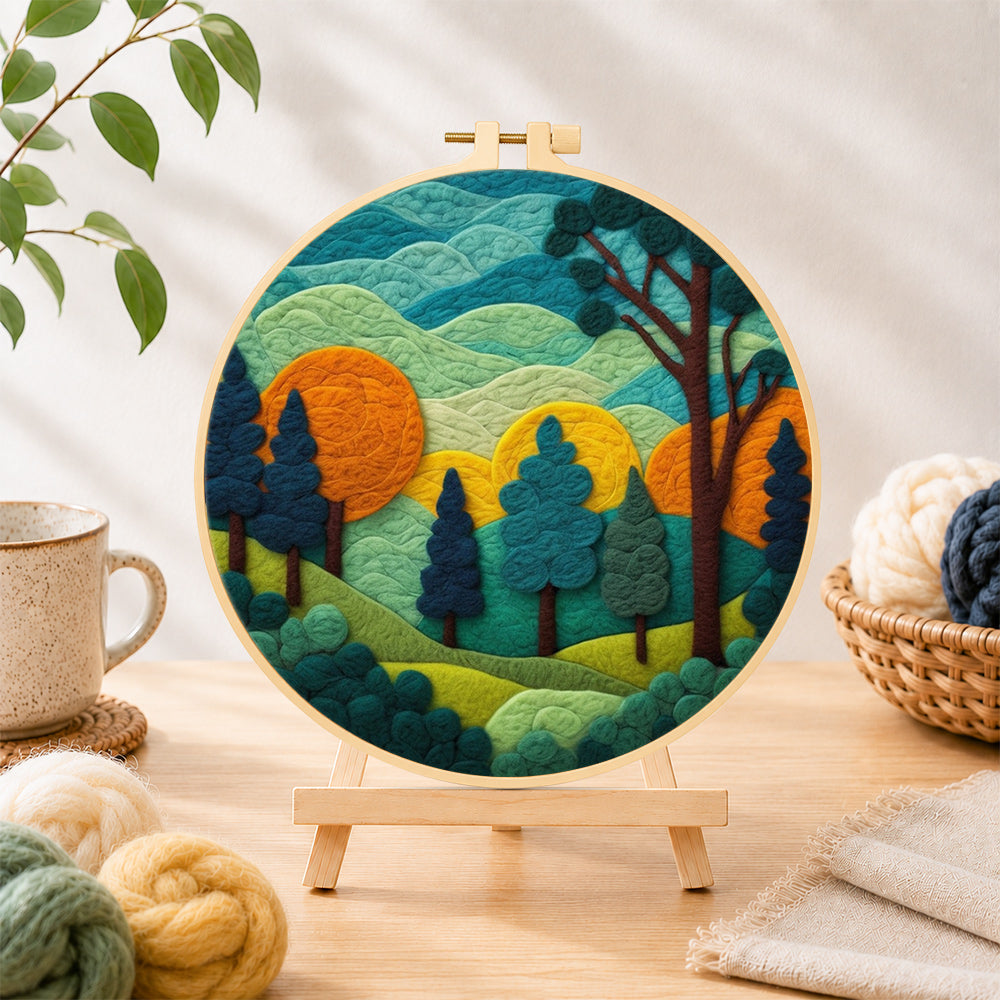 Finished whimsical forest and rolling mountains needle felting displayed on a wooden easel