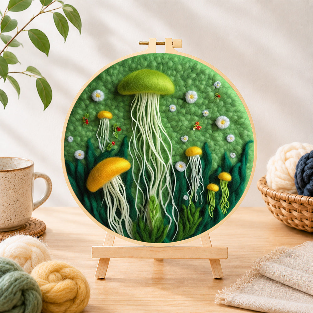 Finished whimsical green and yellow jellyfish needle felting displayed on a wooden easel