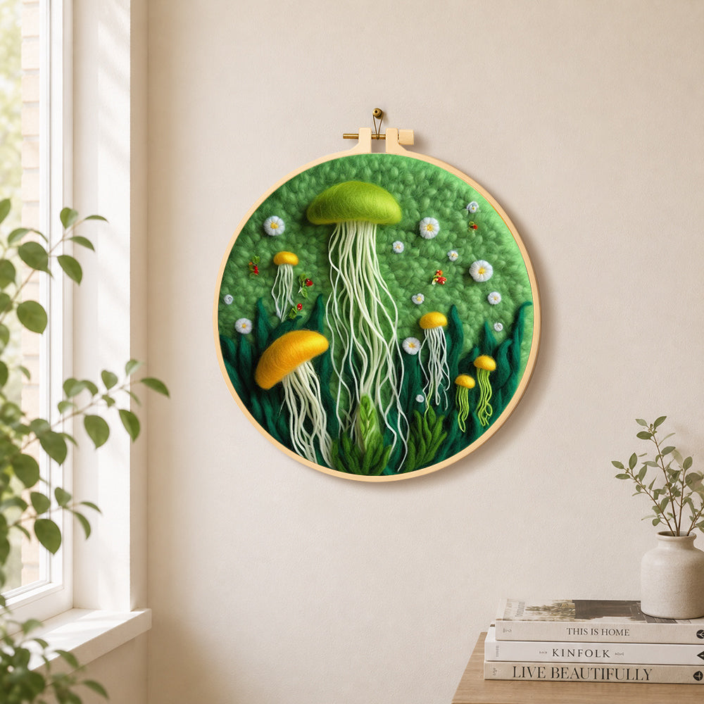 Whimsical green and yellow jellyfish needle felt wall art displayed in a bright home interior