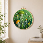 Whimsical green and yellow jellyfish needle felt wall art displayed in a bright home interior