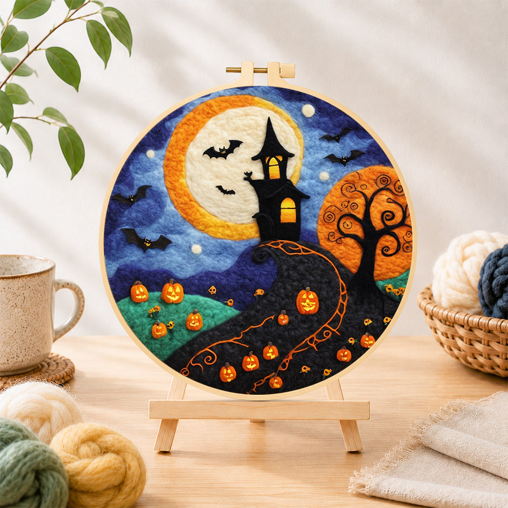 Finished whimsical haunted village and halloween pumpkins needle felting displayed on a wooden easel