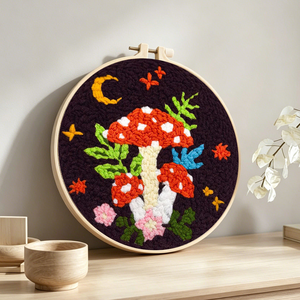 Whimsical mushroom punch needle artwork displayed on a table