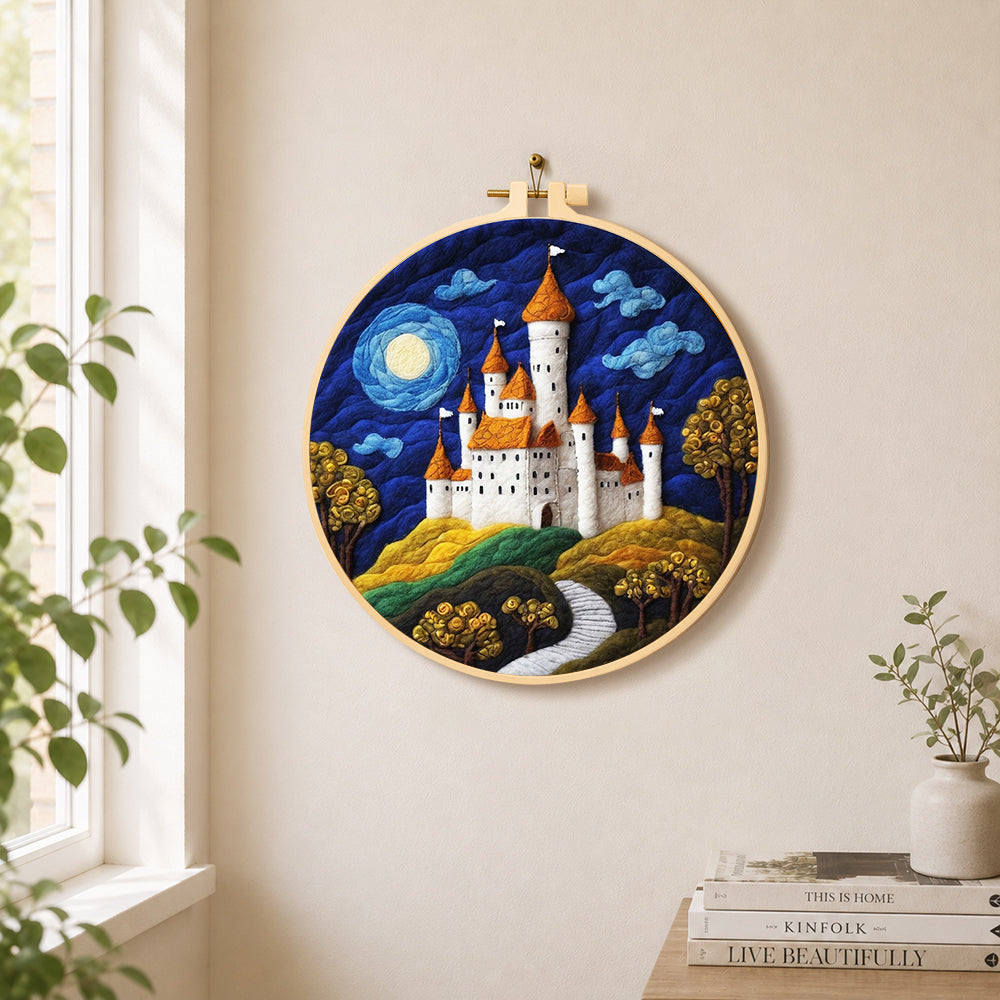 Whimsical white castle and blue moon needle felt wall art displayed in a bright home interior