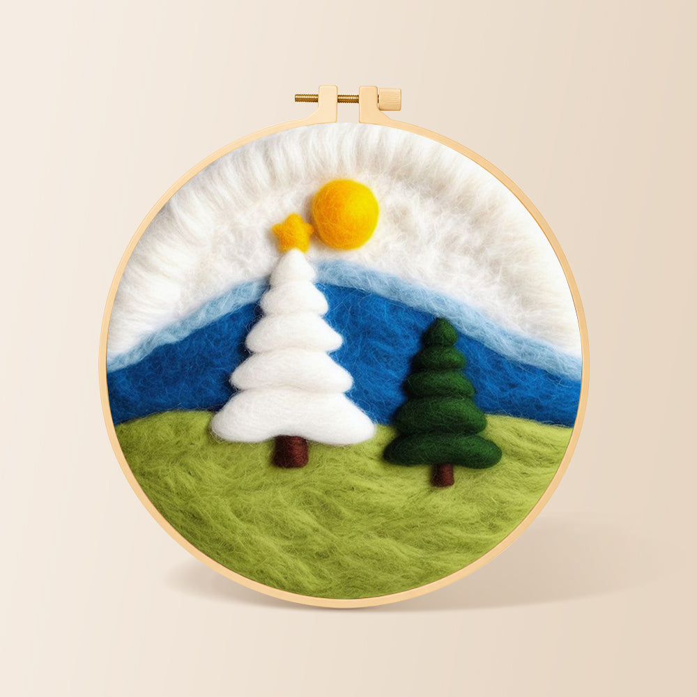 White and green christmas trees on grass needle felting kit for beginners with a round wooden frame