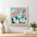 Finished white and pink daisies artwork displayed on a wall
