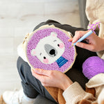 Creating handmade white bear in purple background punch needle artwork