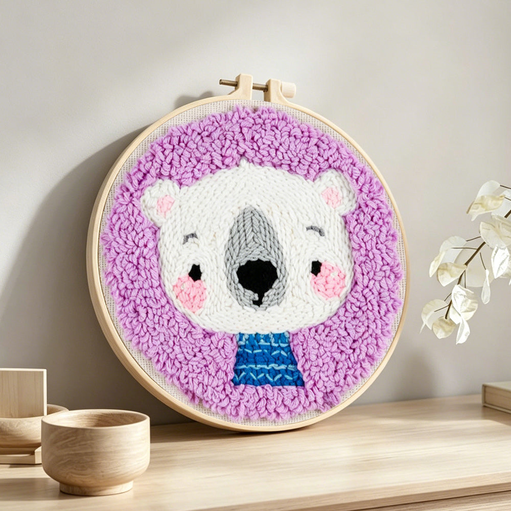 White bear in purple background punch needle artwork displayed on a table