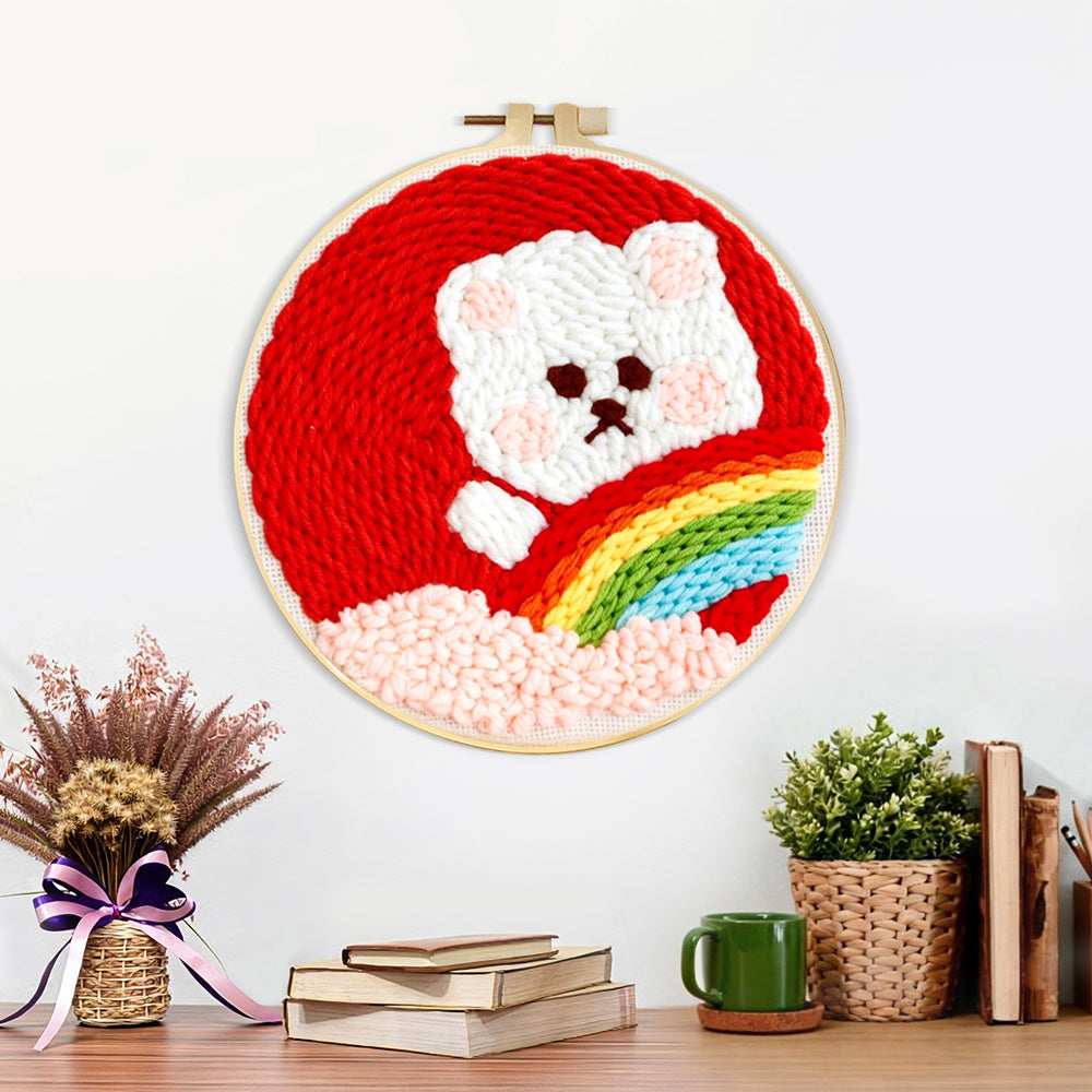 Finished white bear with rainbow artwork displayed on a wall