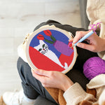 Creating handmade white cat and purple vase punch needle artwork