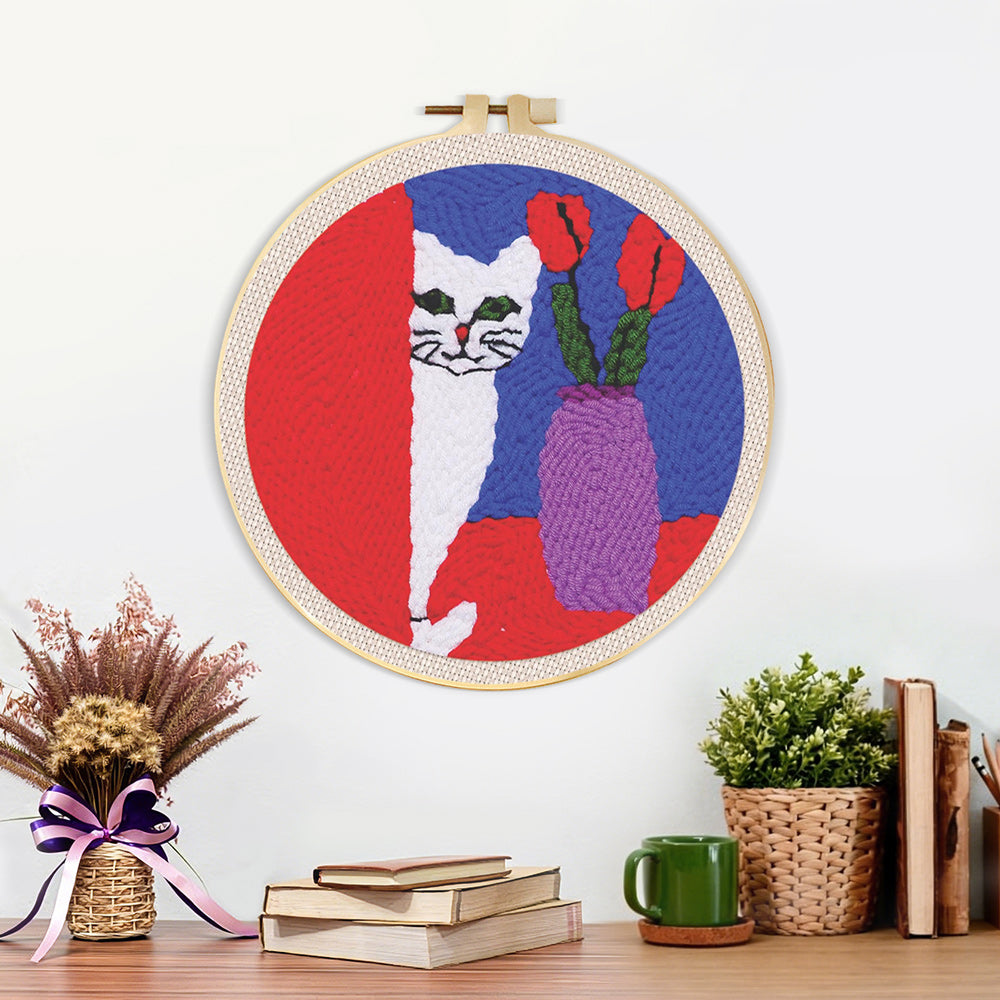 Finished white cat and purple vase artwork displayed on a wall