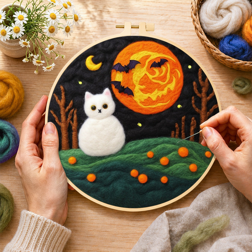 Creating the white cat and spooky orange moon wool painting by hand with a felting needle