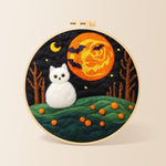 White cat and spooky orange moon needle felting kit for beginners with a round wooden frame